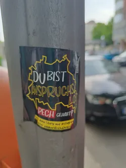 A sticker featuring a stylized map of Germany with the text "Du bist anspruchslos? Pech gehabt?" (You are undemanding? Too bad!).  It also includes a smaller text mentioning Instagram.