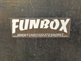 A brown and white sticker with the text FUNBOX and the website www.funboxskateshop.lt