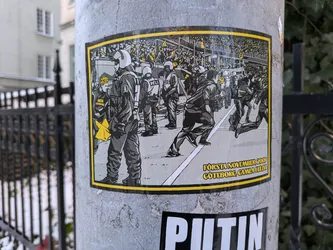 A sticker depicting a scene of police and protesters clashing during a demonstration in Göteborg, Sweden on November 1st, 2009. The illustration is black and white with yellow accents, and text at the bottom indicates the date and location of the event. 