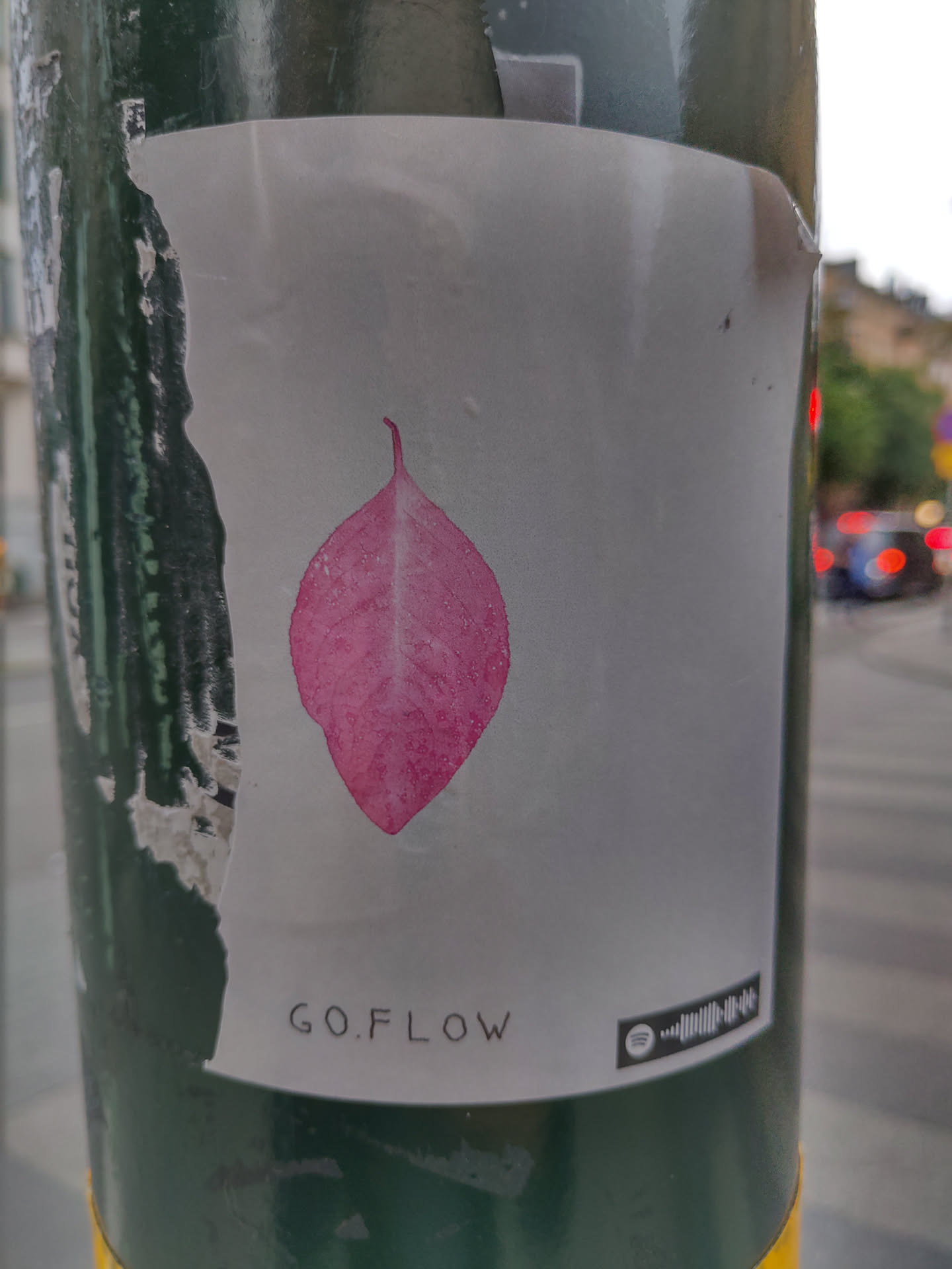 A sticker featuring a pink leaf illustration and the text GO.FLOW. A Spotify code is also present.