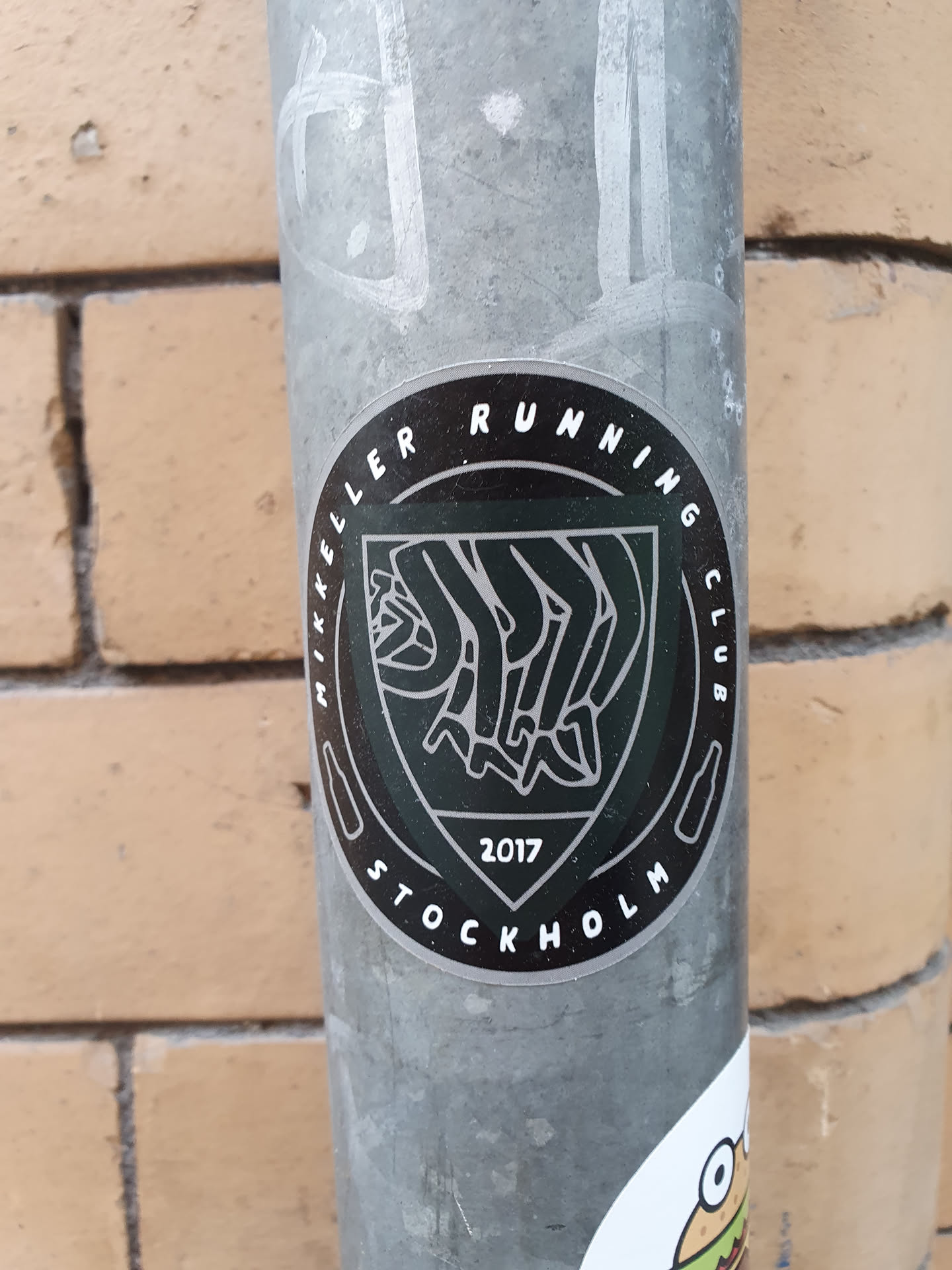 Black and white sticker with the Mikkeller Running Club Stockholm logo. The logo includes the text "Mikkeller Running Club" and "Stockholm" in a circle around a central emblem, which appears to represent runners. The year 2017 is visible at the bottom.