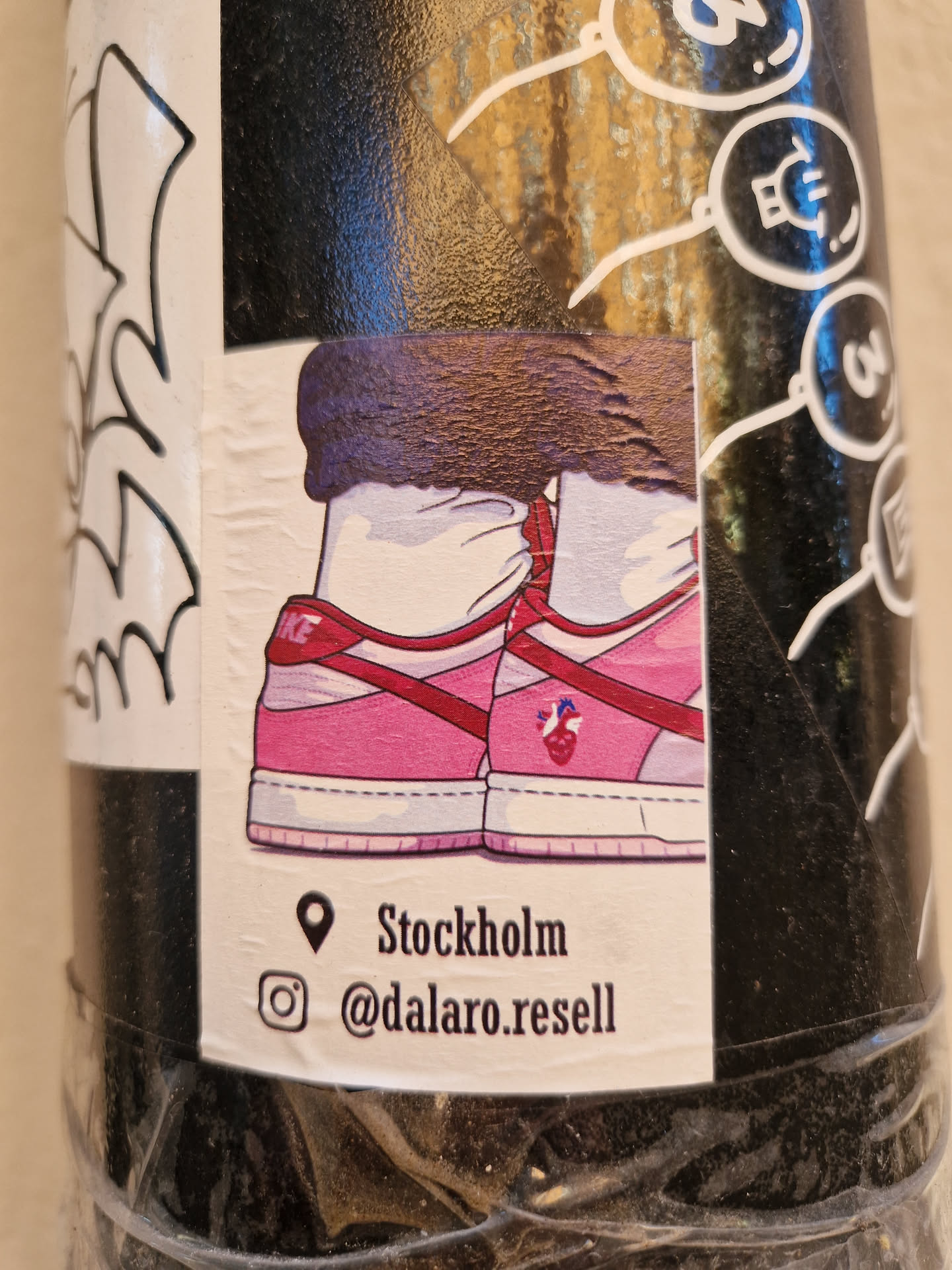 A sticker featuring an illustration of pink sneakers with red accents. The sticker includes location information indicating Stockholm and an Instagram handle @dalaro.resell. 