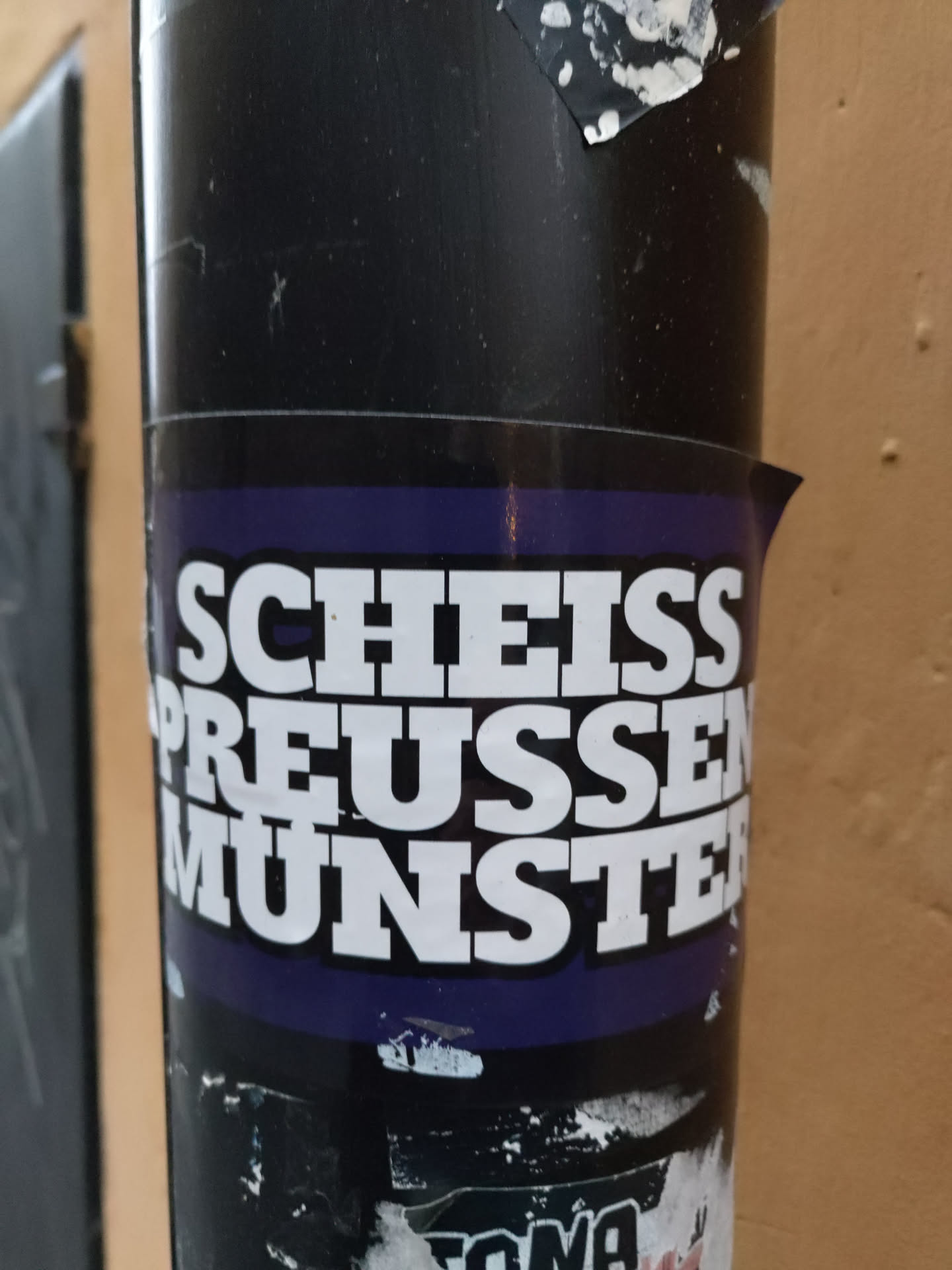A sticker with the text "Scheiss Preussen Munster" on a purple background. The text is in bold, white uppercase letters.