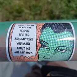 A sticker with a pop art style illustration of a person's face and a speech bubble with text. The text challenges gender assumptions.