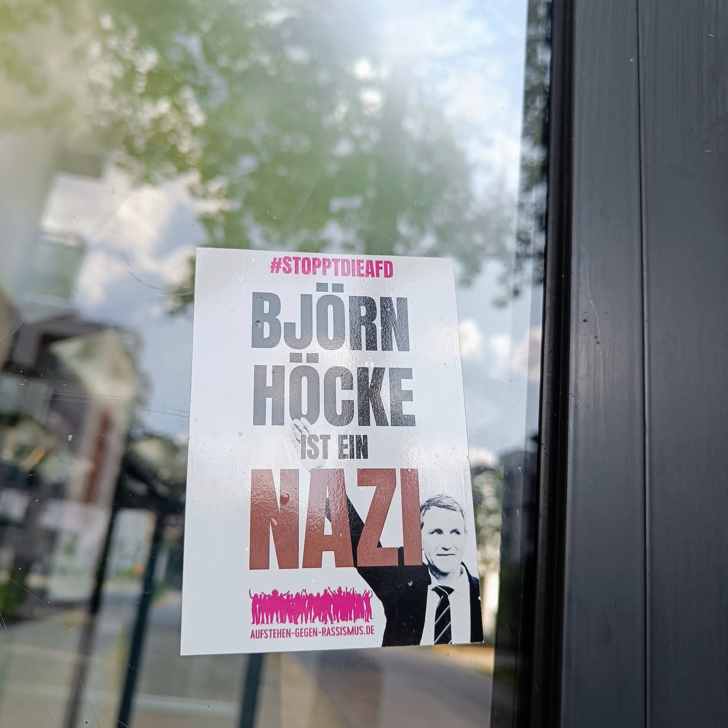 A sticker with a picture of Björn Höcke and the text "Björn Höcke ist ein Nazi" (#StopptDieAfD).  The sticker also contains a website address at the bottom.
