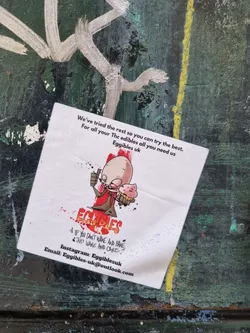 A sticker advertising Eggibles UK, a company that provides THC edibles. The sticker features a cartoon illustration and contact information.