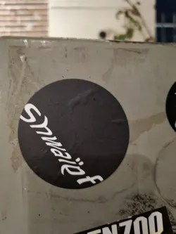A round black and white sticker with the word \"Stwviet\" written in a stylized font.  The sticker is affixed to a light gray surface.