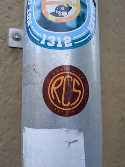 Street sticker A round sticker featuring a deep maroon-red background. At the center is an intertwined, stylized monogram logo reading 'RCS' enclosed in a thin gold circle. Along the outer top rim, the text 'ROMA CLUB' is arched in gold capital letters, and 'SVEZIA' is curved along the bottom edge in the same color and typeface.