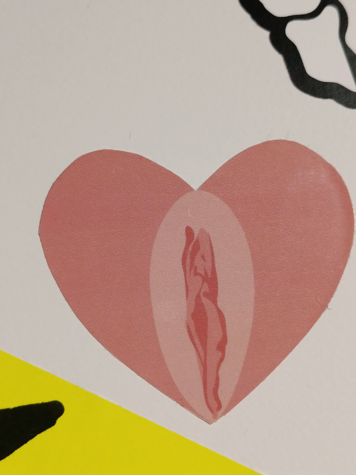 A pink heart-shaped sticker with a stylized vulva inside. The sticker is simple yet powerful, promoting body positivity and self-love.