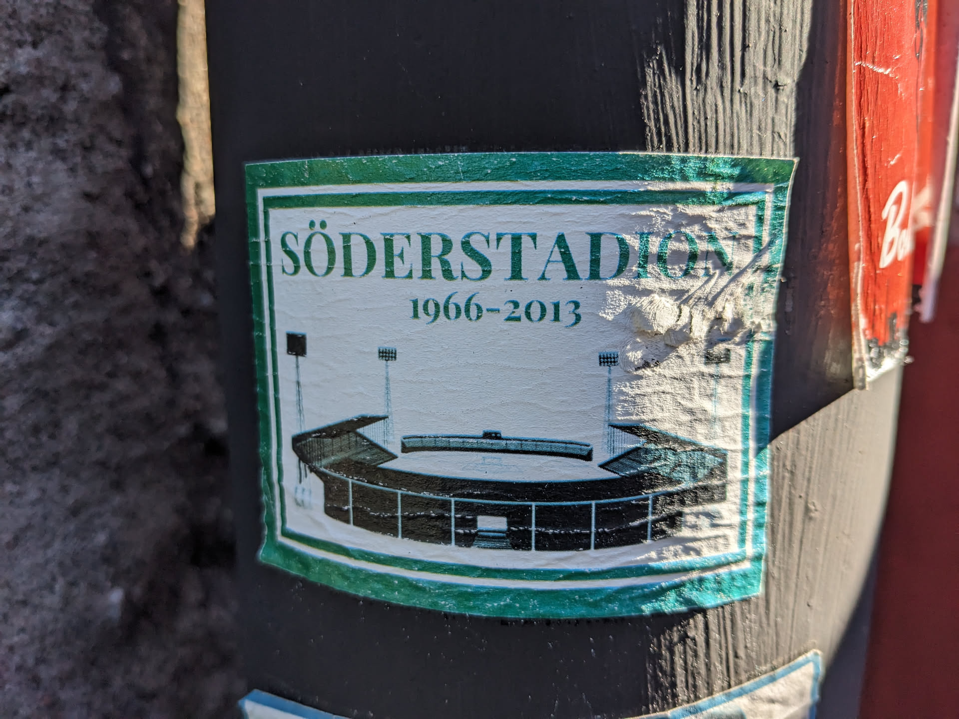 A sticker commemorating Söderstadion, a football stadium in Stockholm, Sweden, that was in use from 1966 to 2013. The sticker features a simple illustration of the stadium.