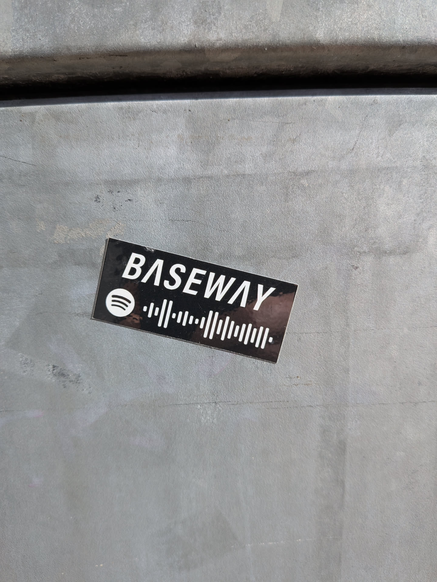 A rectangular sticker with a black background. White text reading 'BASEWAY' is prominently displayed at the top. Below the text is the Spotify logo, followed by a Spotify code, which is a black and white barcode-like pattern used to link directly to music on the Spotify platform.