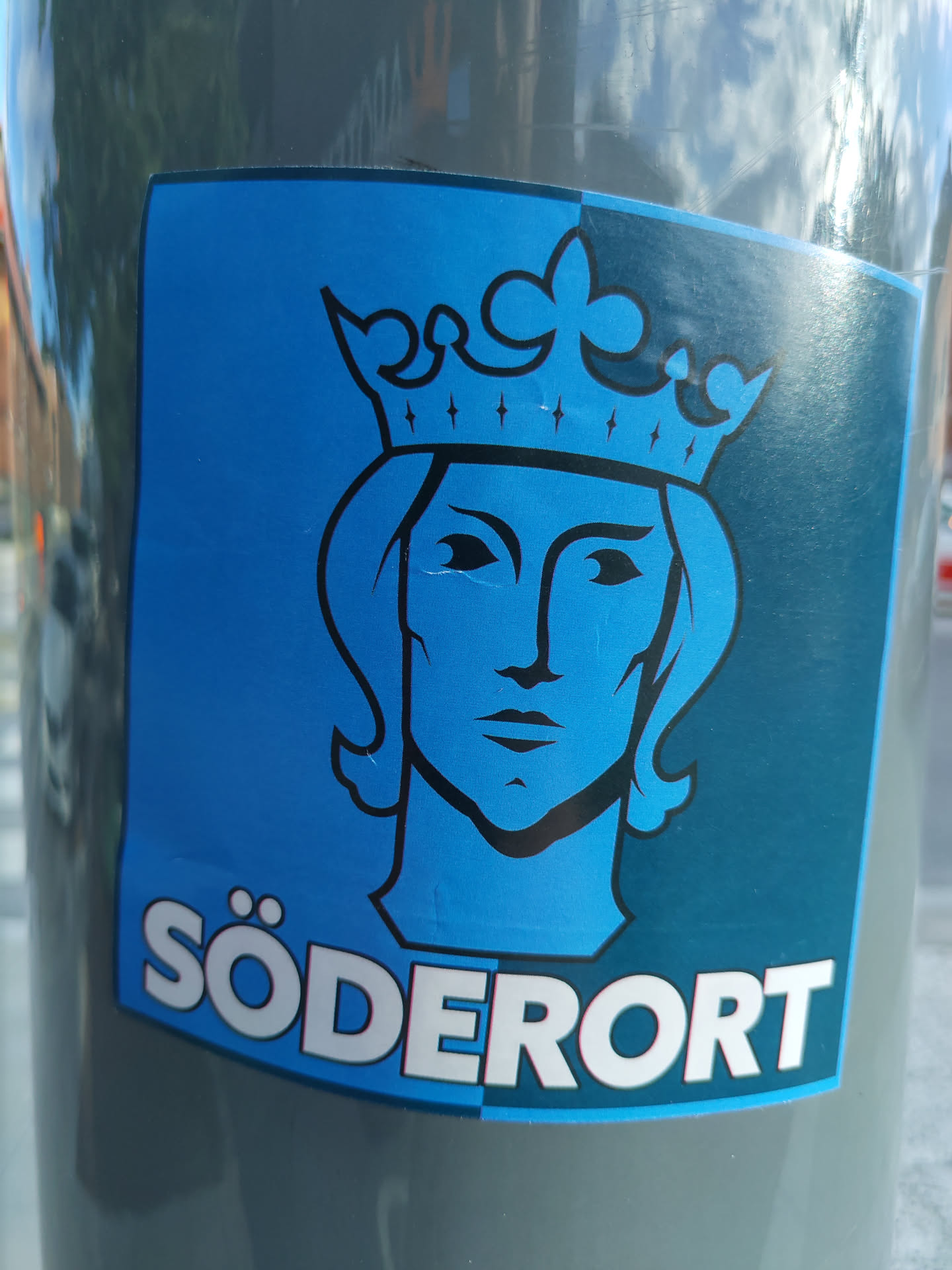 A sticker featuring a stylized illustration of a king's head wearing a crown, set against a blue and dark teal background. The word "Södermalm" is written at the bottom.