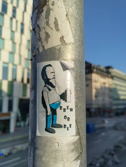 A sticker featuring a cartoon illustration of a man holding a beer mug. The text 'Brew or Die' is prominently displayed. The art style is simple and slightly humorous.