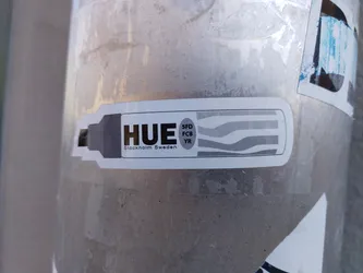 A sticker featuring the word HUE, along with the text "Stockholm Sweden" and a graphic design resembling color stripes.