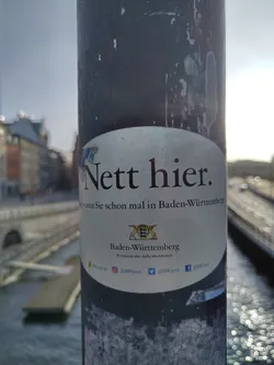 Sticker promoting tourism in Baden-Württemberg, Germany. It features the coat of arms of the state and social media links.