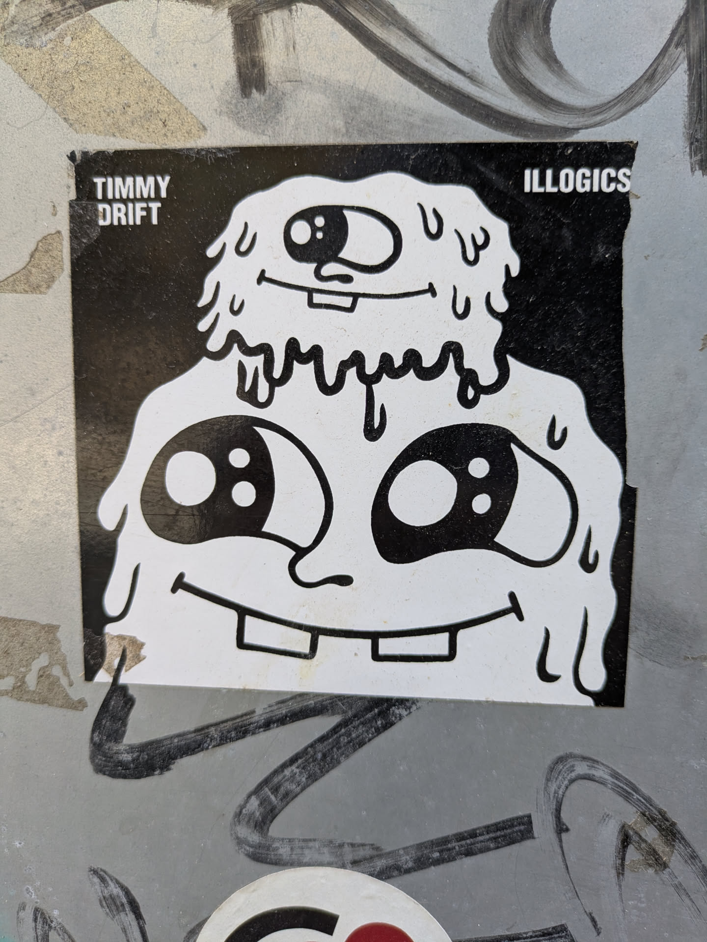 This sticker showcases a cartoon character with two heads, rendered in black and white with a melting effect. The design has a playful, slightly grotesque aesthetic. The sticker is adhered to a textured surface.