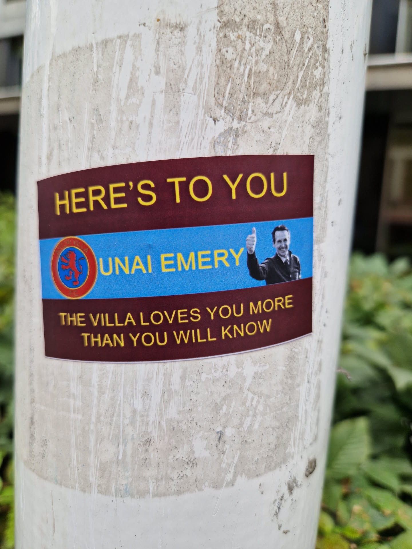 A sticker showing Unai Emery, Aston Villa's manager, with a thumbs up. The sticker has a maroon and blue color scheme with the Aston Villa crest.