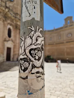 A sticker featuring two anatomical hearts with visible clockwork mechanisms inside. The style is reminiscent of vintage anatomical illustrations.