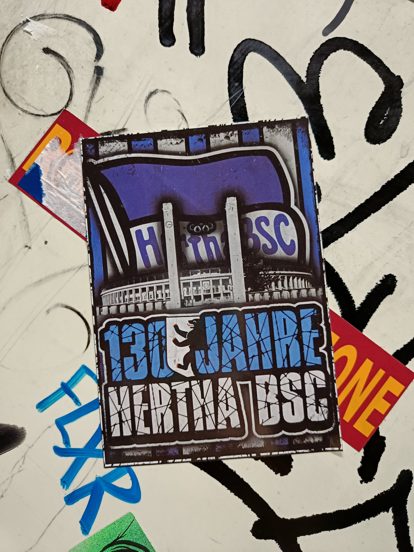 A sticker commemorating 130 years of Hertha BSC, a German football club. The sticker features a stylized image of the Olympiastadion in Berlin and the club's logo.