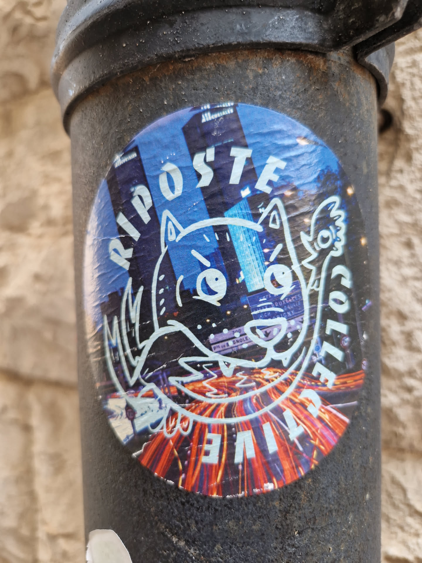 A round sticker featuring a stylized cartoon fox or wolf amidst a cityscape backdrop. The words "RIPOSTE COLLECTIVE" are written around the central image. The style is graphic and slightly edgy.