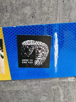 Black and white sticker of a cobra with the text "Here to end you".