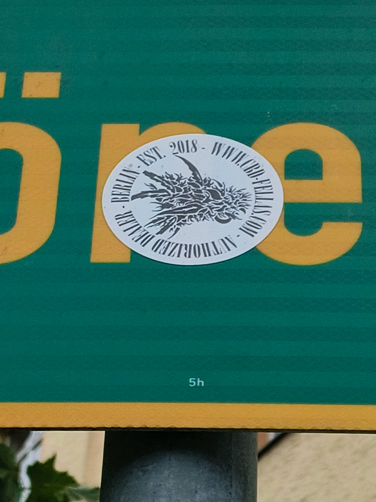 Round white sticker with a black and grey illustration of a dragon-like claw. The text around the image reads: "BERLIN - EST. 2018 - WWCD - FULLY AUTHORIZED"