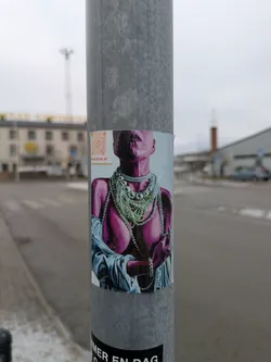 This sticker showcases vibrant, stylized artwork of a woman's upper body, draped in numerous pearl necklaces. The color palette is striking, with the woman rendered in shades of pink and purple against a lighter blue background. A small QR code is visible in one corner.