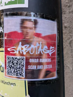 A sticker featuring Omar Rudberg's music.  The sticker has a QR code to listen to the song. The main image is blurry, likely due to the sticker's condition.