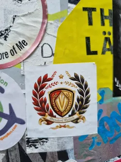 Sticker featuring a heraldic emblem with a shield, laurel wreath, and a banner reading "Standard Clutch". The style is reminiscent of vintage or classic design.
