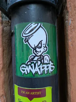 A sticker featuring an illustration of a GWA10PP character. The character has a halo and a mischievous expression. The sticker is on a dark-colored pipe.