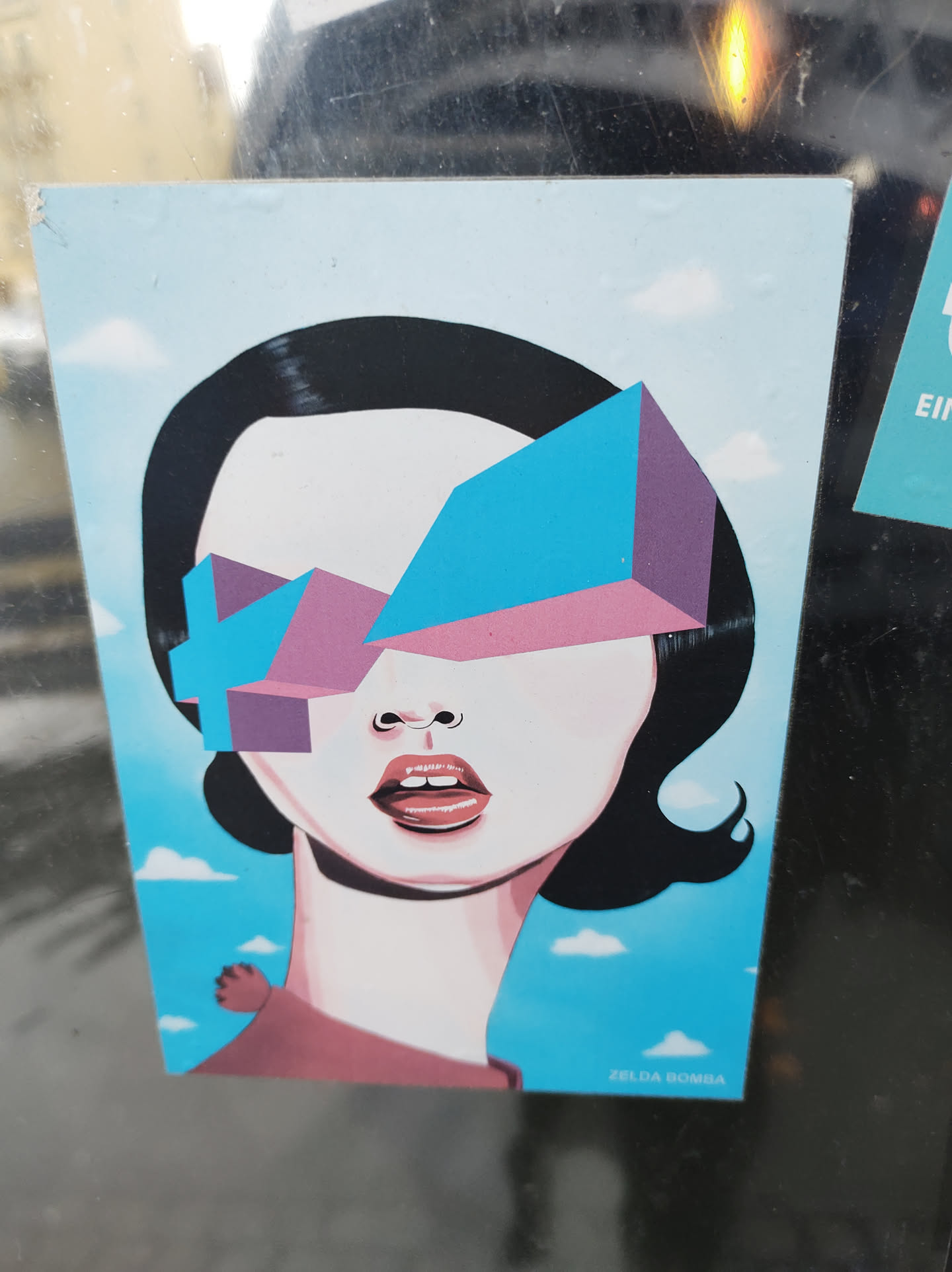 A stylish sticker featuring a woman's face with geometric sunglasses. The art style is minimalist and colorful, with a blue and pink color scheme. The background is a simple light blue sky with small clouds.