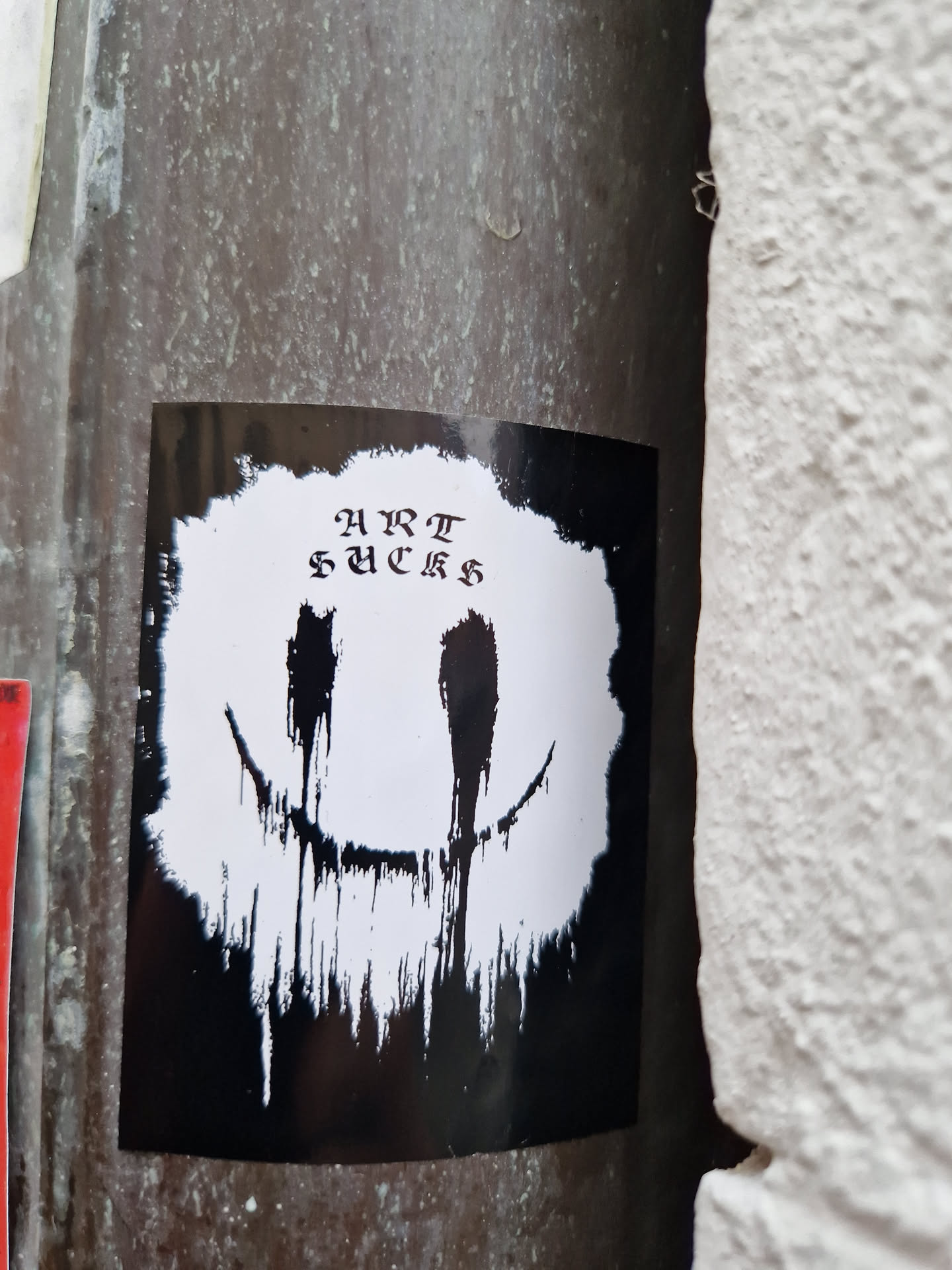 Black and white sticker with a dripping smiley face and the words "HURT FEELINGS" written in a stylized font. The style is reminiscent of grunge or dark art.