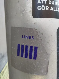 A minimalistic sticker with the word "LINES" and five vertical lines underneath it. The sticker is a light gray color with dark purple lines and text.