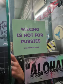 A light green square sticker with a bold message in purple text.  It promotes a defiant attitude towards waxing. The sticker includes an Instagram handle.