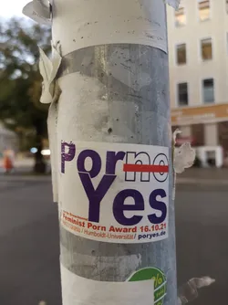 A sticker promoting the Feminist Porn Award on a pole.  The word "no" is crossed out in the sticker's design.