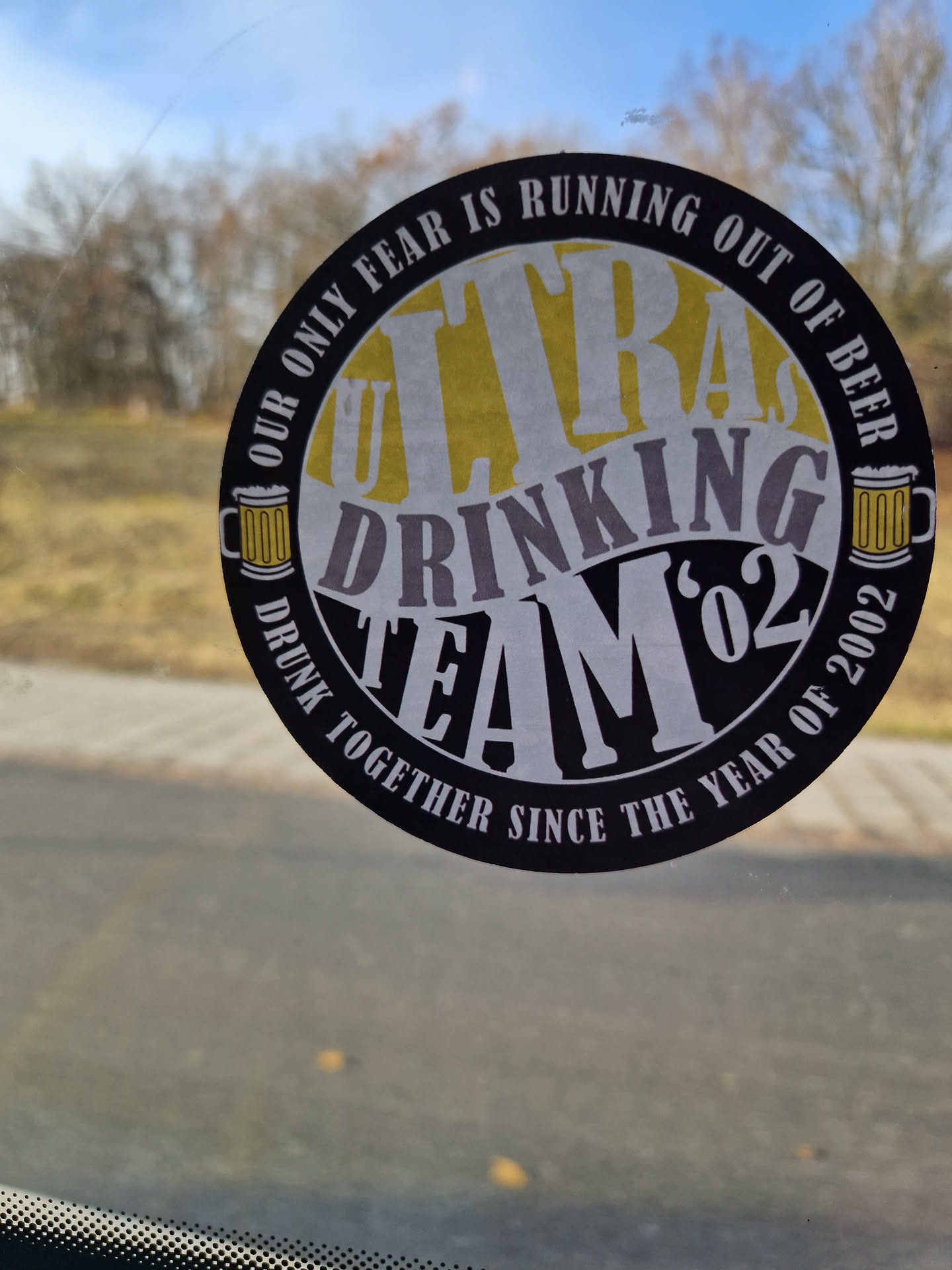 Round sticker with the text 'Ultra Drinking Team'02' and the phrase 'Our only fear is running out of beer'. It also mentions that the team has been drunk together since 2002.