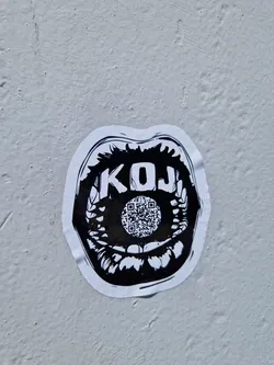 Black and white sticker depicting a mouth with the letters KOJ and a QR code in the center. The style is graphic and slightly edgy.
