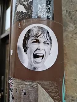 Black and white sticker of a woman screaming. It's a scene from the movie Psycho.