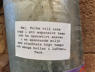 The sticker is attached to a metal pole. The text on the sticker appears to be a polite refusal of a job offer or collaboration.  The tone is respectful and explains the reasons for declining the opportunity.