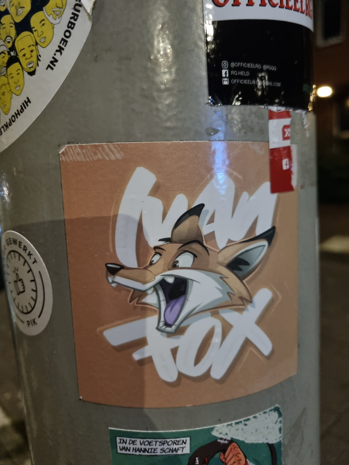A sticker featuring a cartoon fox with the text 'Mad Fox'. The sticker is light brown with white lettering. 