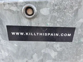 A black rectangular sticker with the website address www.killthispain.com written in white.