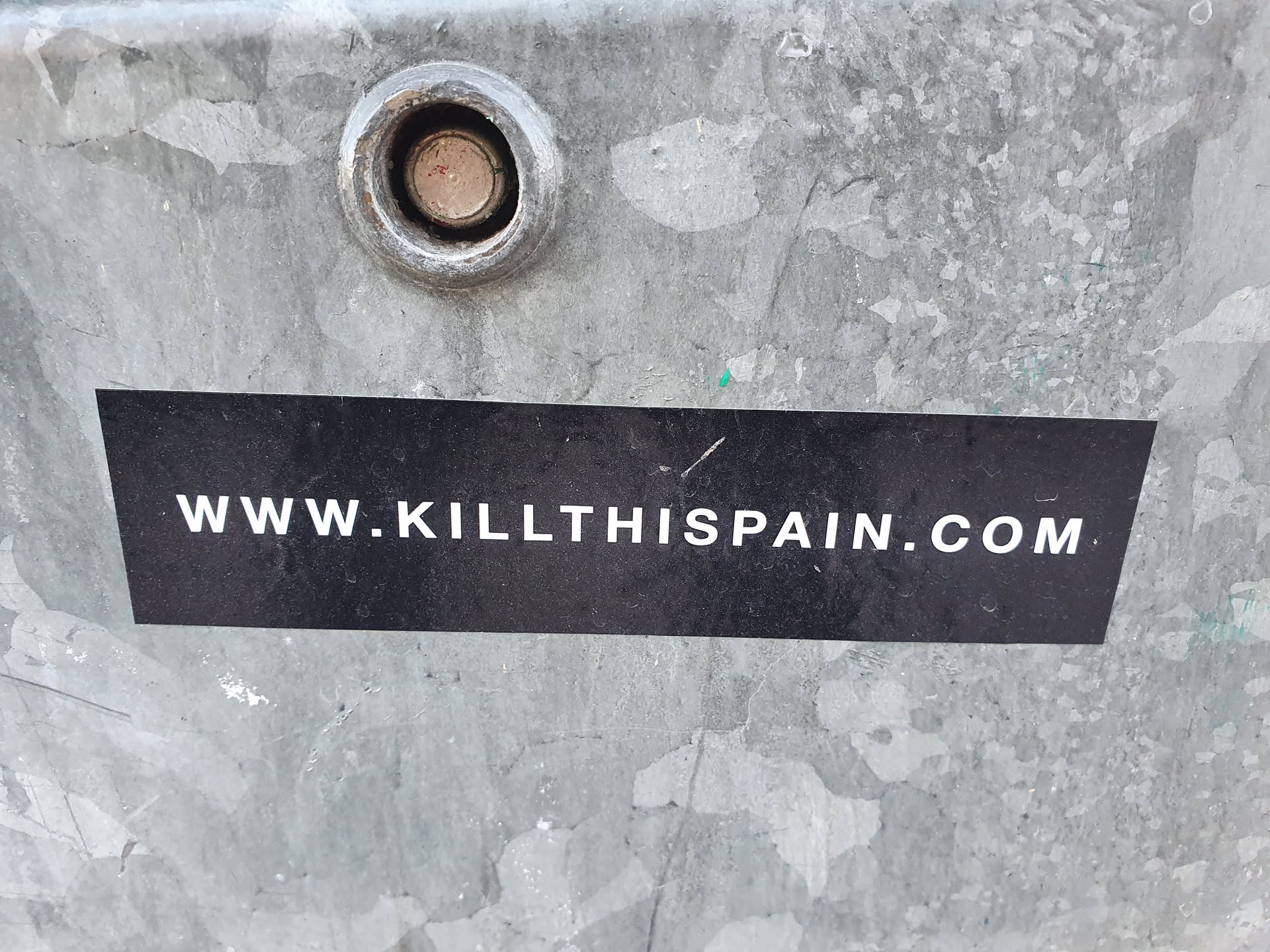 A black rectangular sticker with the website address www.killthispain.com written in white.