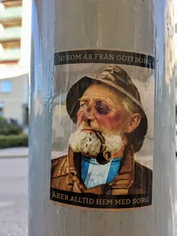 A sticker depicting an old sailor with a black eye, smoking a pipe. The text on the sticker translates to: "Those from Gothenburg always return home with sorrow."