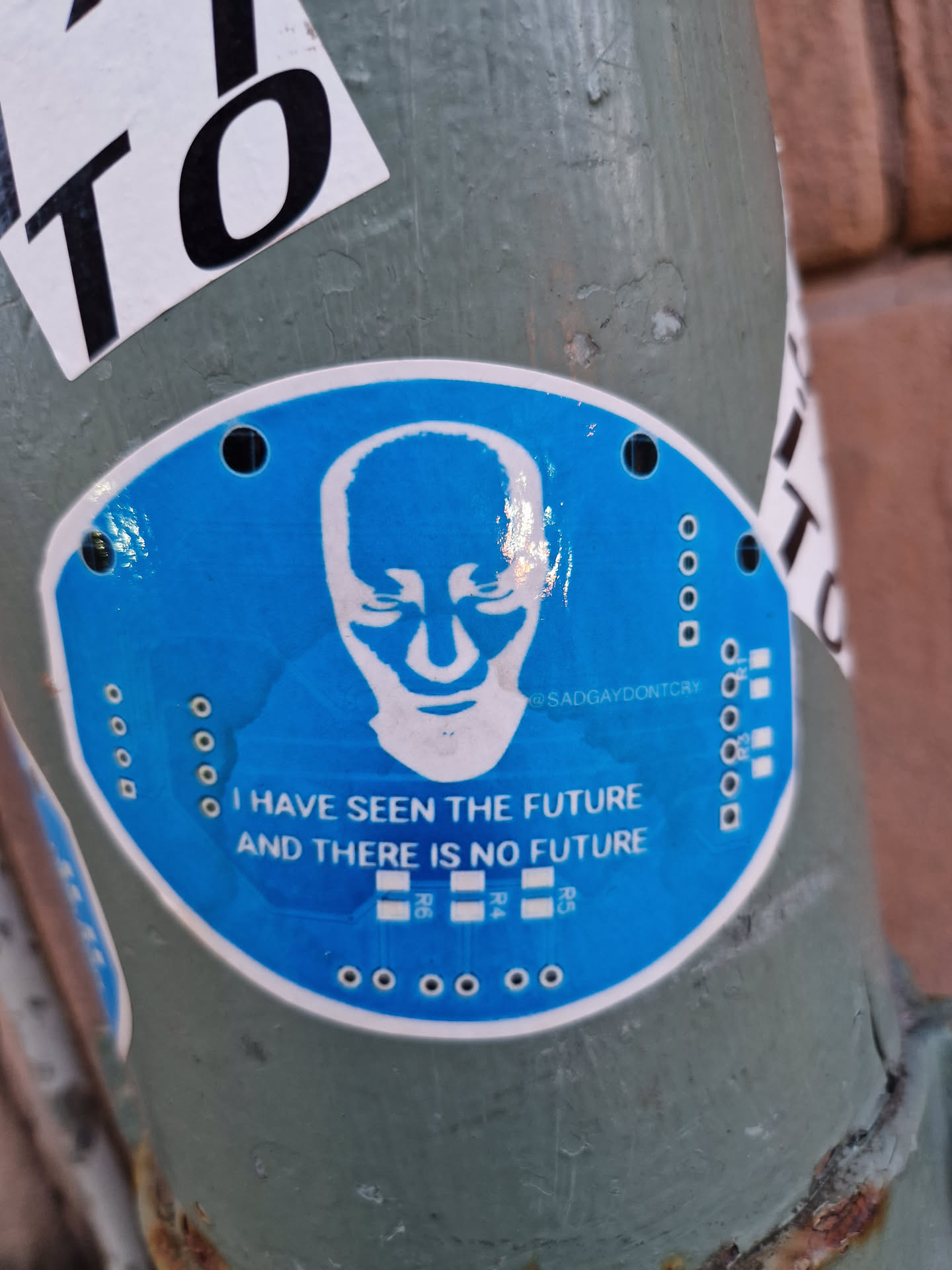 Round blue sticker with a stylized head and the text "I have seen the future and there is no future".  The sticker has a design that resembles a circuit board.