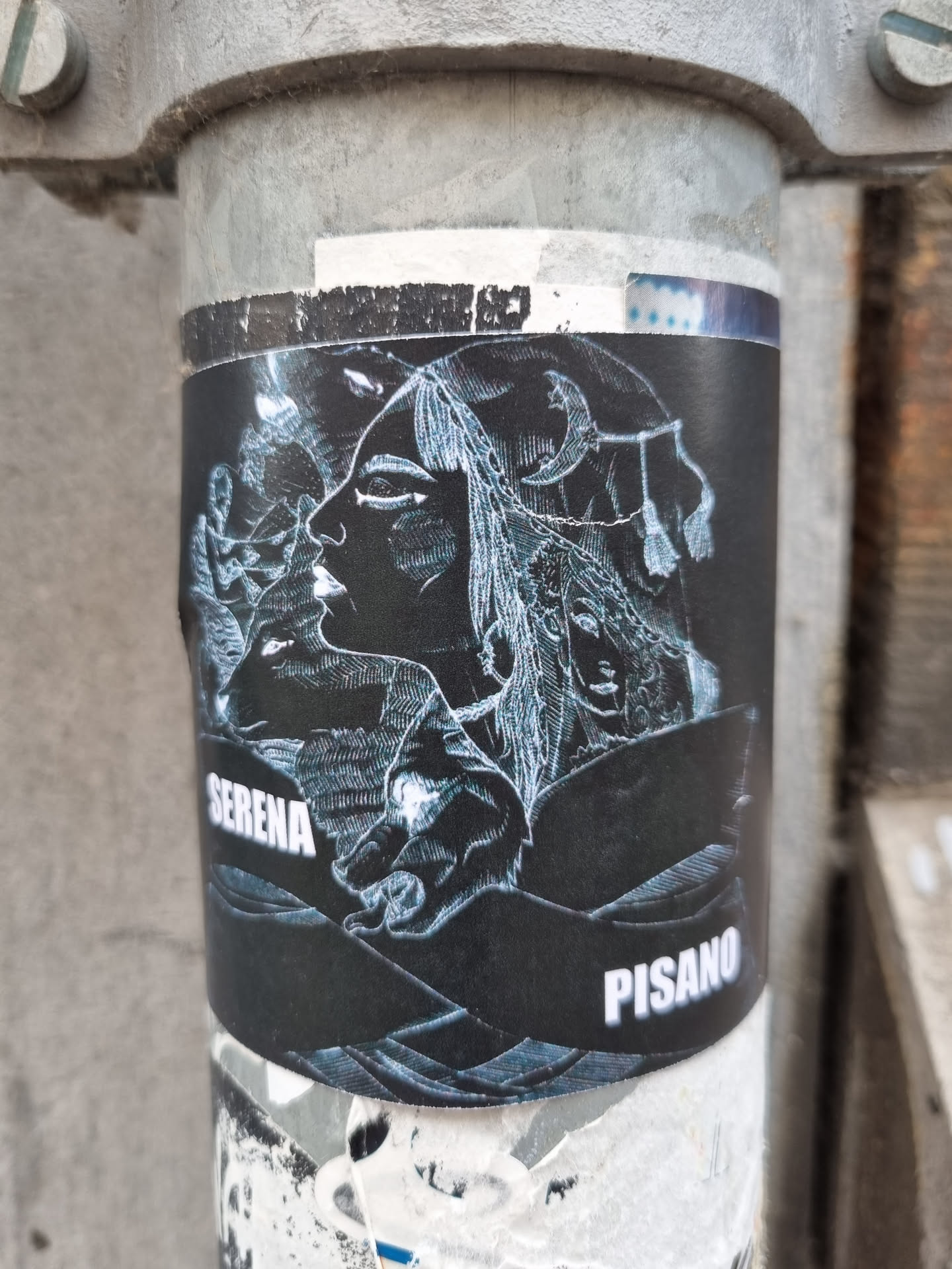 Black and white sticker featuring a detailed illustration of a woman's face with flowing hair, possibly in a mystical or ethereal style. The artist's name, Serena Pisano, is visible at the bottom of the design.