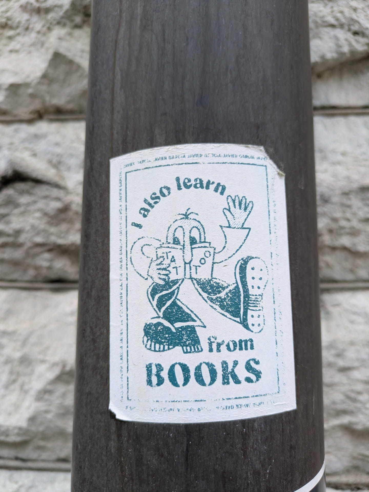 A sticker featuring a cartoon character reading a book. The text on the sticker says "I also learn from BOOKS".