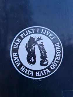 This sticker is black and white and circular. It shows two boots with text around them. The text is in Swedish and translates to "Our duty in life hate hate hate Gothenburg". The design is simple but striking. It's likely a statement piece expressing a strong opinion.