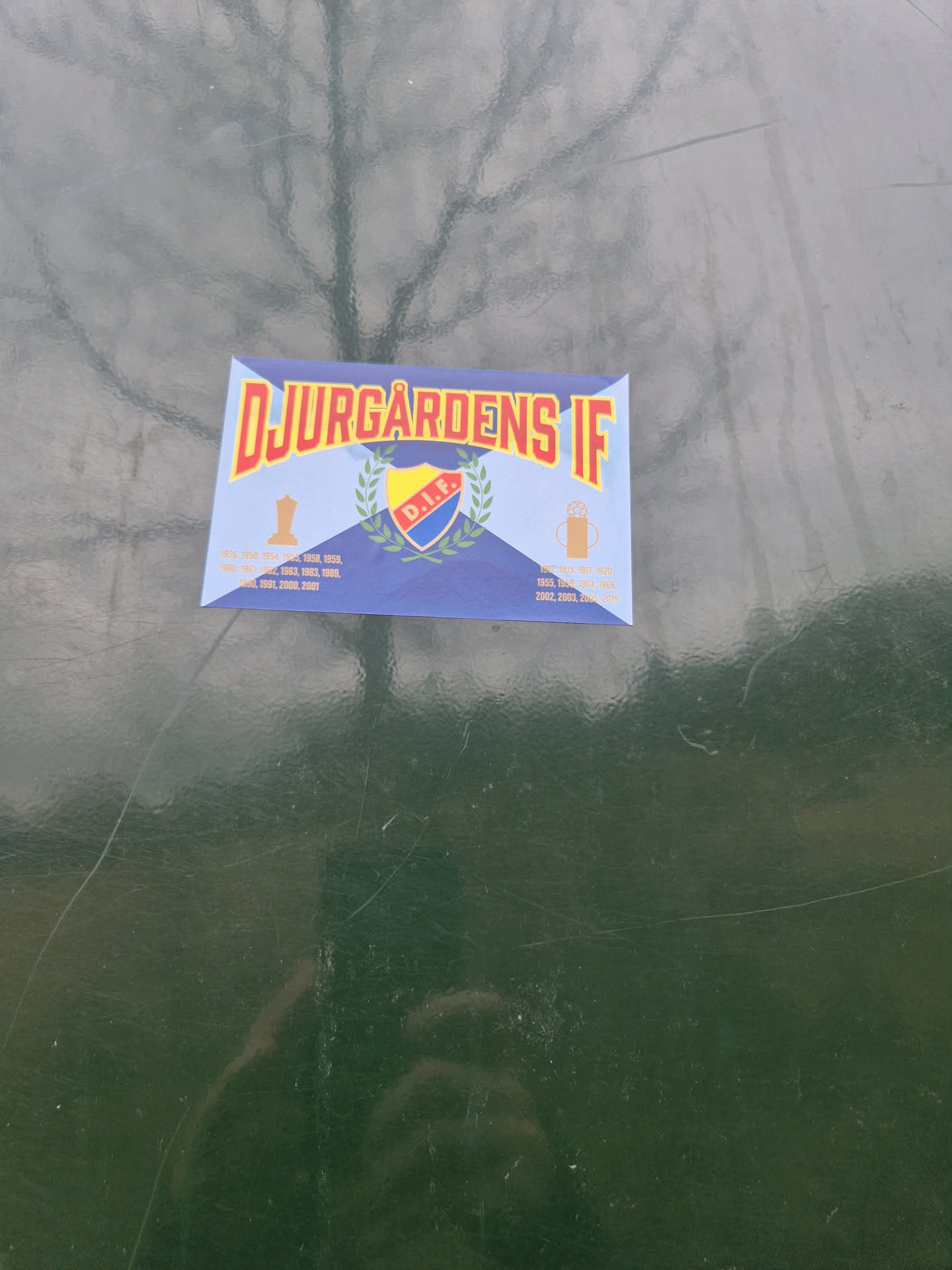 A Djurgården IF sticker featuring the club's logo and various years. The sticker is blue, red, yellow and white.