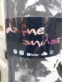 Black sticker with the text "dafne and klaus" written in pink and white.  At the bottom, there are social media icons for Spotify, Apple Music, YouTube, SoundCloud, and Instagram.