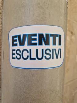 A sticker with the text "EVENTI ESCLUSIVI" which means "Exclusive Events" in Italian. The sticker has a simple design with black text on a white background and a blue border.